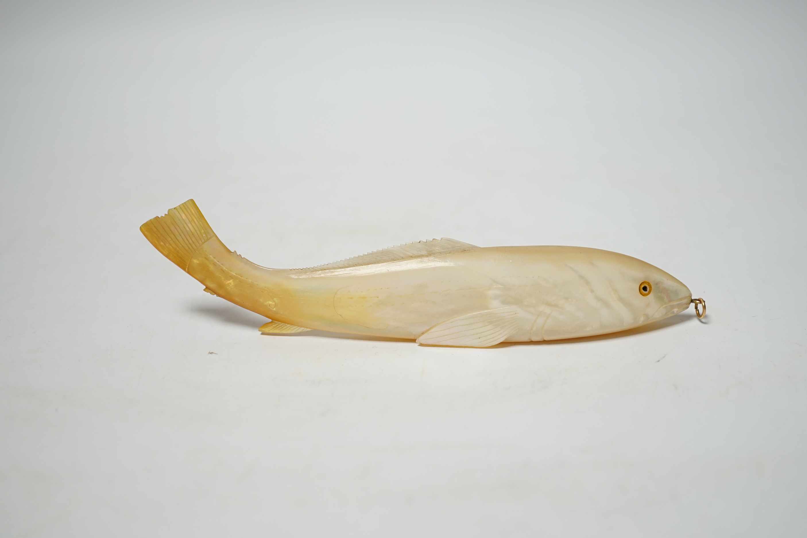 A carved mother of pearl model of a fish, 15.5cm